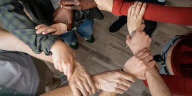 Photo of people holding hands to shape a circle